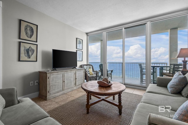 521 W Beach Blvd Unit 1702, Gulf Shores, AL 36542 - living area featuring expansive windows, light tile patterned floors, and a textured ceiling