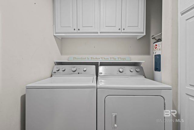 521 W Beach Blvd Unit 1702, Gulf Shores, AL 36542 - laundry room with washing machine and dryer and cabinet space