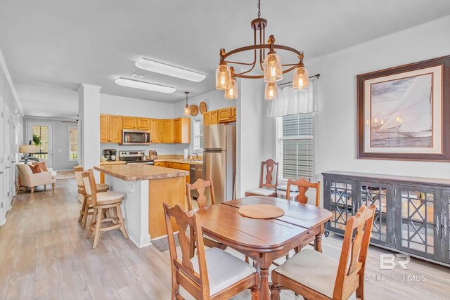 25806 Pollard Rd Unit 204, Daphne, AL 36526 - dining room featuring plenty of natural light, light wood finished floors, and a chandelier