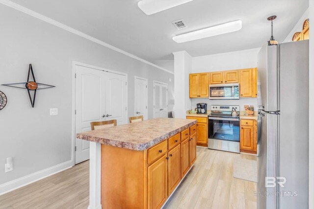 25806 Pollard Rd Unit 204, Daphne, AL 36526 - kitchen with appliances with stainless steel finishes, light wood finished floors, light countertops, and ornamental molding