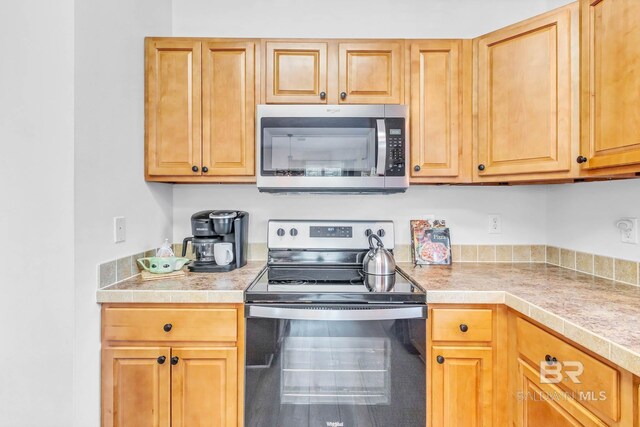 25806 Pollard Rd Unit 204, Daphne, AL 36526 - kitchen with stainless steel appliances and tile countertops