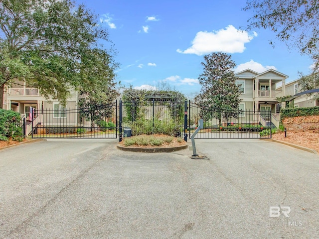 25806 Pollard Rd Unit 204, Daphne, AL 36526 - view of asphalt street with a gate, a gated entry, and curbs