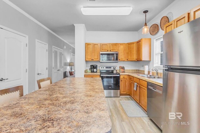 25806 Pollard Rd Unit 204, Daphne, AL 36526 - kitchen with appliances with stainless steel finishes, light wood-style floors, light countertops, crown molding, and decorative light fixtures