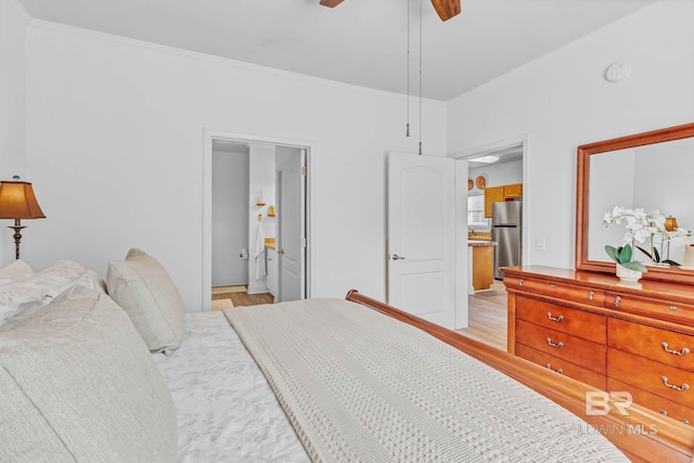 25806 Pollard Rd Unit 204, Daphne, AL 36526 - bedroom with freestanding refrigerator, light wood finished floors, ornamental molding, ensuite bath, and a ceiling fan