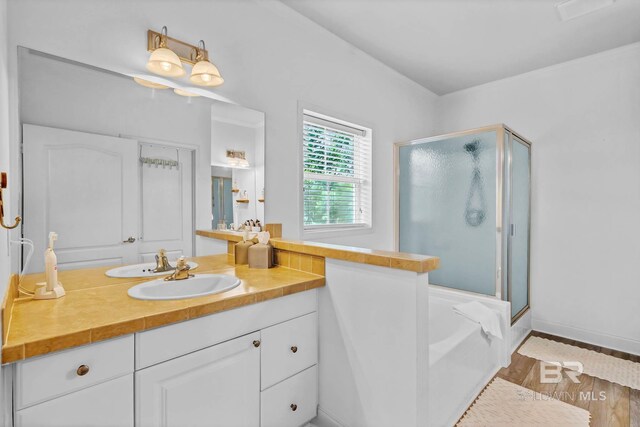 25806 Pollard Rd Unit 204, Daphne, AL 36526 - full bathroom with a shower stall, vanity, a garden tub, and wood finished floors