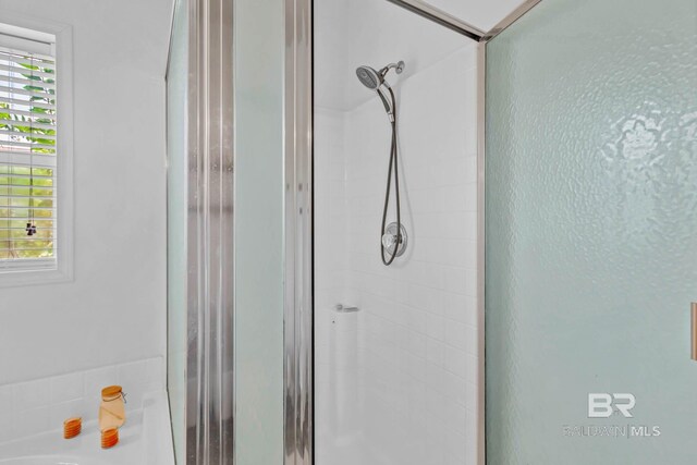 25806 Pollard Rd Unit 204, Daphne, AL 36526 - bathroom featuring a stall shower and a tub to relax in