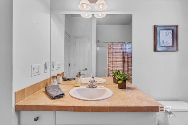 25806 Pollard Rd Unit 204, Daphne, AL 36526 - bathroom with vanity and curtained shower