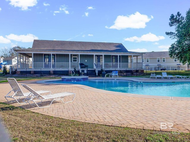 25806 Pollard Rd Unit 204, Daphne, AL 36526 - view of swimming pool featuring a patio area and a pool with connected hot tub