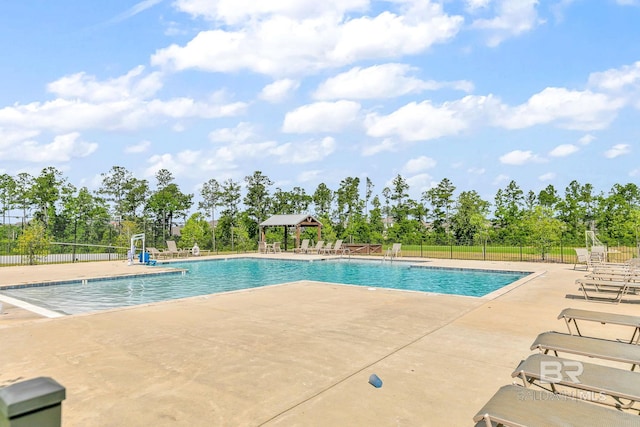 pool featuring a gazebo, a patio, and fence