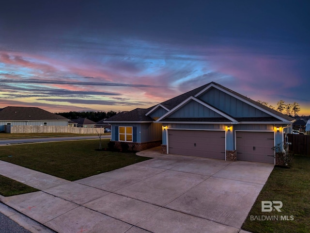 view of front of property with driveway, fence, board and batten siding, a front yard, and a garage