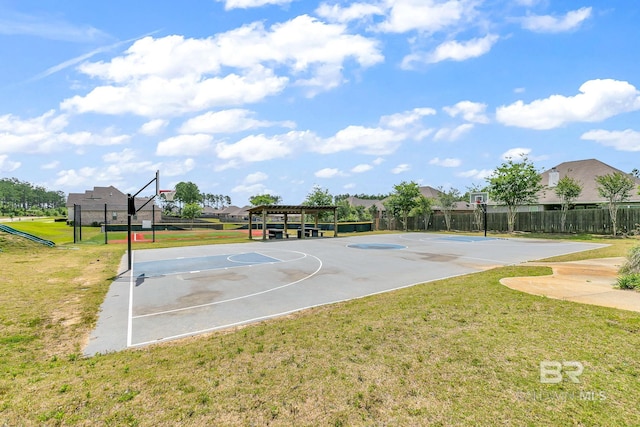 view of basketball court with community basketball court, a yard, and fence