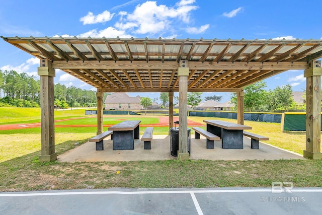 view of property's community with a yard and a patio area