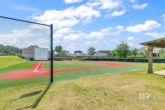 view of property's community with fence and a lawn