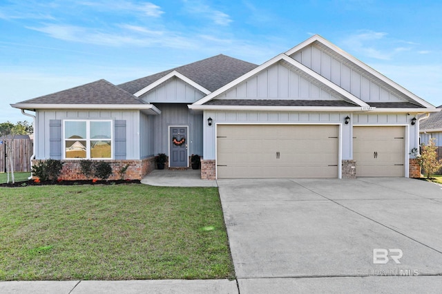 view of front of property featuring driveway, a front lawn, roof with shingles, an attached garage, and brick siding