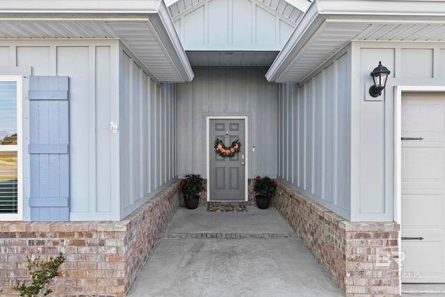 entrance to property with board and batten siding and brick siding