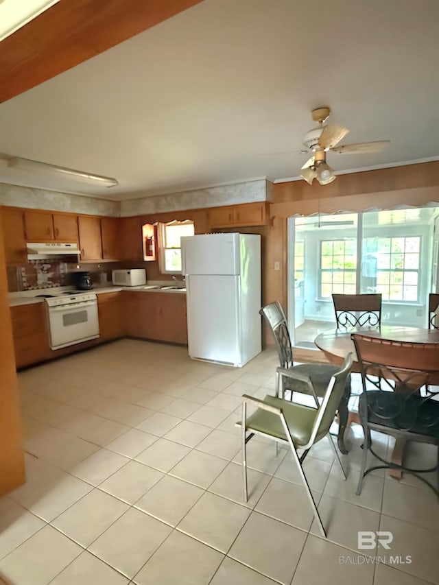 358 Satsuma St, Fairhope, AL 36532 - kitchen featuring white appliances, ceiling fan, light countertops, under cabinet range hood, and light tile patterned floors
