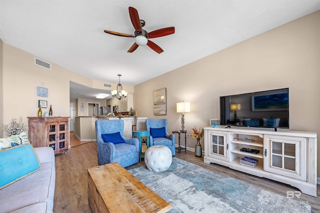 527 Beach Club Trl Unit C305, Gulf Shores, AL 36542 - living room with wood finished floors, visible vents, baseboards, and ceiling fan with notable chandelier