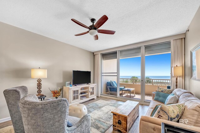 527 Beach Club Trl Unit C305, Gulf Shores, AL 36542 - living room with a ceiling fan, wood finished floors, and a textured ceiling
