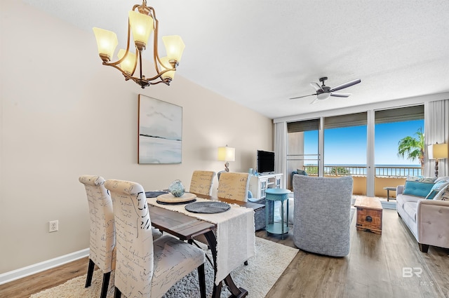 527 Beach Club Trl Unit C305, Gulf Shores, AL 36542 - dining room featuring ceiling fan with notable chandelier, baseboards, and wood finished floors