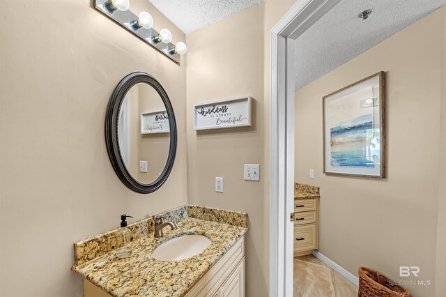 527 Beach Club Trl Unit C305, Gulf Shores, AL 36542 - bathroom with baseboards, vanity, and a textured ceiling