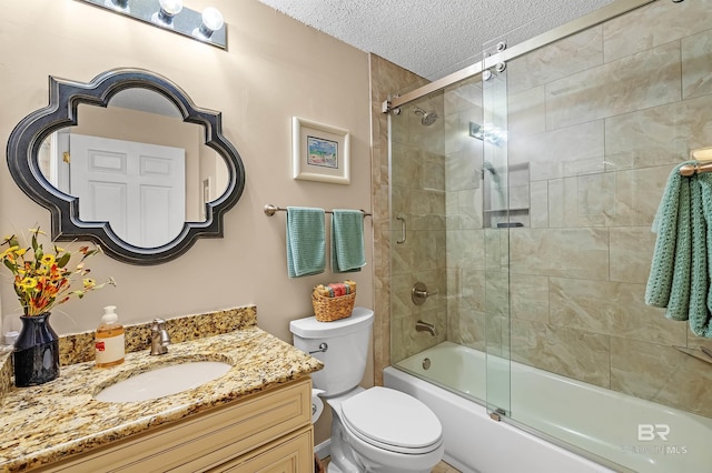 527 Beach Club Trl Unit C305, Gulf Shores, AL 36542 - full bath featuring toilet, vanity, a textured ceiling, and shower / bath combination with glass door