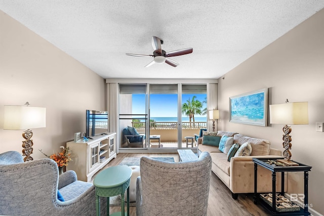 527 Beach Club Trl Unit C305, Gulf Shores, AL 36542 - living room with a wall of windows, wood finished floors, a textured ceiling, and ceiling fan