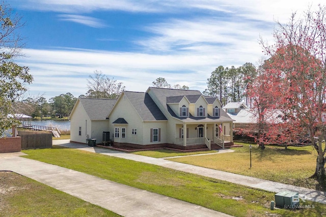 new england style home with a front lawn, a porch, and cooling unit