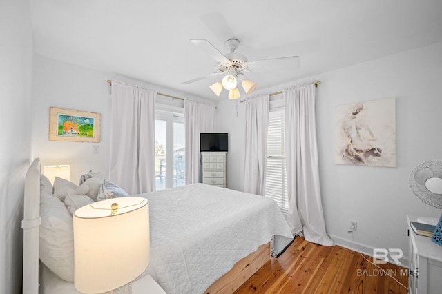 316 Quivira St, Dauphin Island, AL 36528 - bedroom featuring baseboards, a ceiling fan, and wood finished floors
