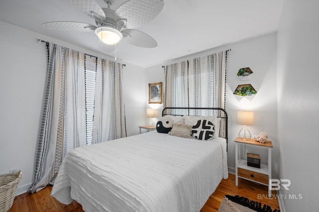 316 Quivira St, Dauphin Island, AL 36528 - bedroom featuring a ceiling fan, wood finished floors, baseboards, and multiple windows