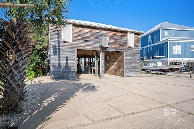 316 Quivira St, Dauphin Island, AL 36528 - back of house featuring a carport and driveway