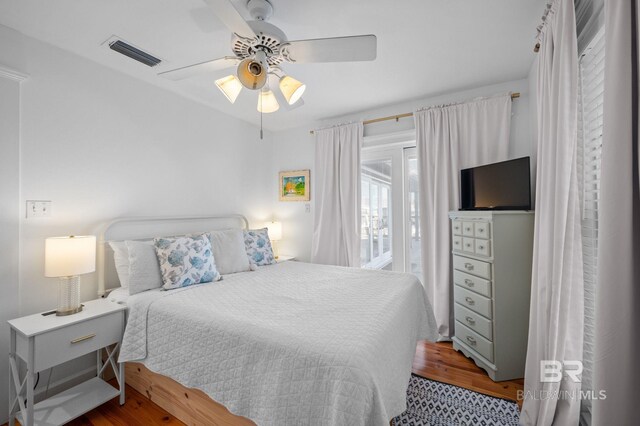 316 Quivira St, Dauphin Island, AL 36528 - bedroom featuring wood finished floors, a ceiling fan, and visible vents