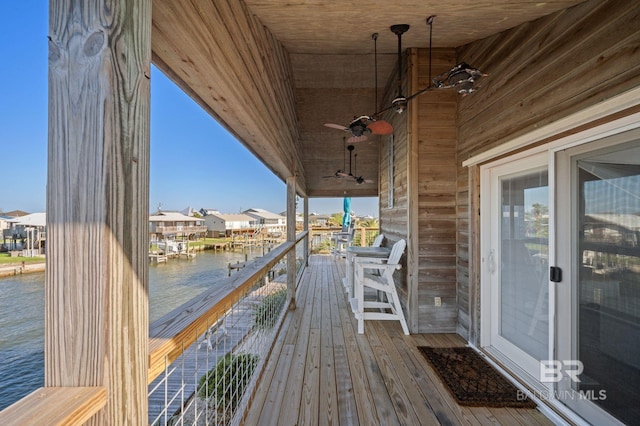 316 Quivira St, Dauphin Island, AL 36528 - wooden terrace with ceiling fan, a residential view, and a water view