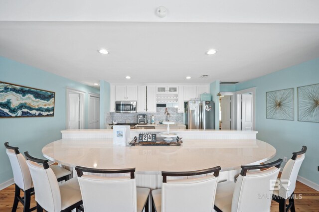 316 Quivira St, Dauphin Island, AL 36528 - dining space featuring wood finished floors, baseboards, and recessed lighting