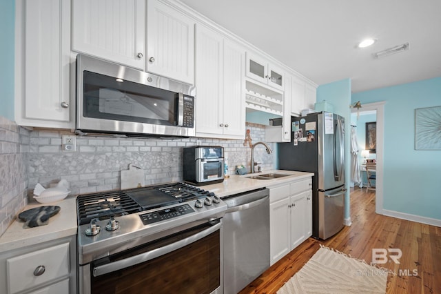 316 Quivira St, Dauphin Island, AL 36528 - kitchen featuring white cabinets, visible vents, appliances with stainless steel finishes, light countertops, and a sink