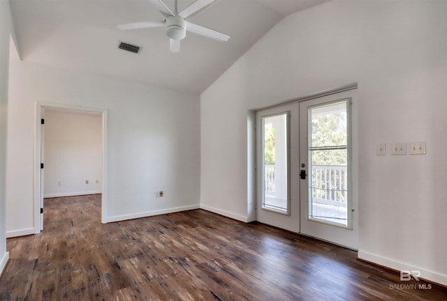 spare room with baseboards, dark wood-style floors, high vaulted ceiling, and ceiling fan
