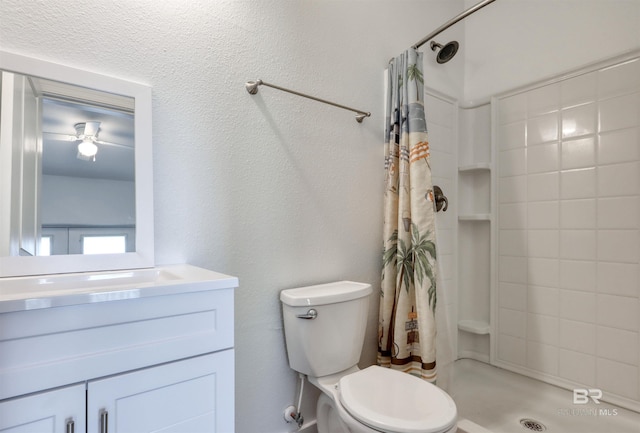 bathroom featuring vanity, toilet, and a stall shower