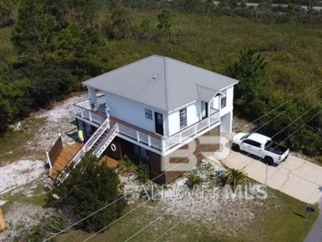 birds eye view of property with a view of trees