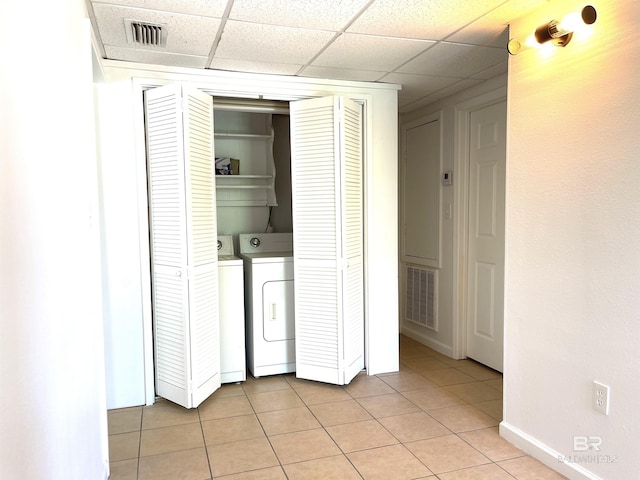 laundry area featuring independent washer and dryer, visible vents, light tile patterned floors, and laundry area