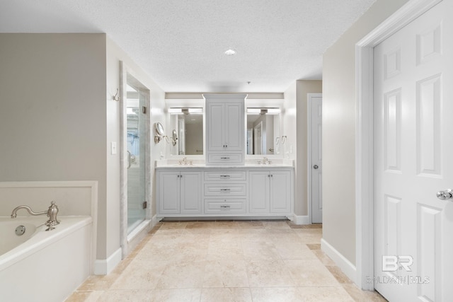 375 Beach Club Dr Unit 1801, Gulf Shores, AL 36542 - bathroom featuring a shower stall, a garden tub, double vanity, baseboards, and a textured ceiling