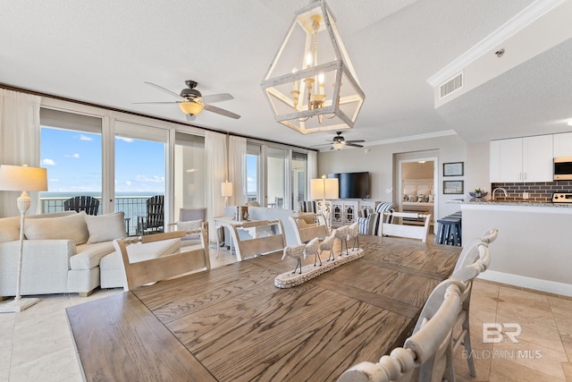 375 Beach Club Dr Unit 1801, Gulf Shores, AL 36542 - dining room featuring ceiling fan, a chandelier, crown molding, and light tile patterned flooring