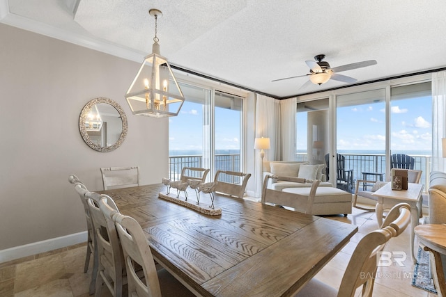375 Beach Club Dr Unit 1801, Gulf Shores, AL 36542 - dining space with ceiling fan, a water view, a chandelier, baseboards, and ornamental molding