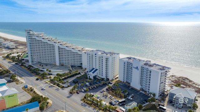 aerial view with a water view and a beach view