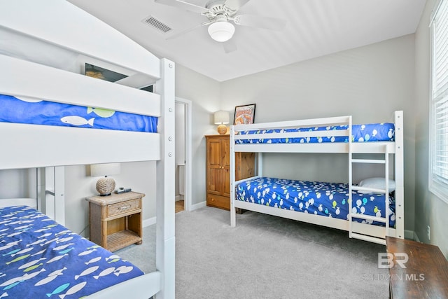 bedroom with multiple windows, ceiling fan, and carpet floors