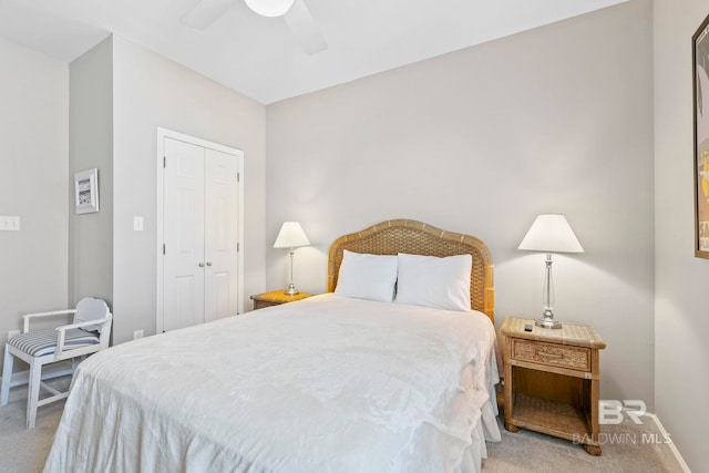 carpeted bedroom with ceiling fan and a closet