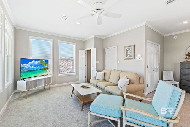 living room featuring ceiling fan, crown molding, and light carpet