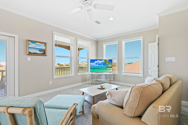 living room featuring crown molding, ceiling fan, and carpet flooring