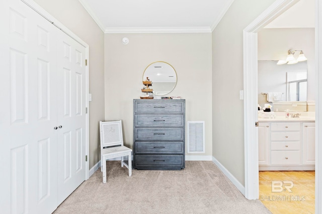 living area featuring light carpet, sink, and ornamental molding