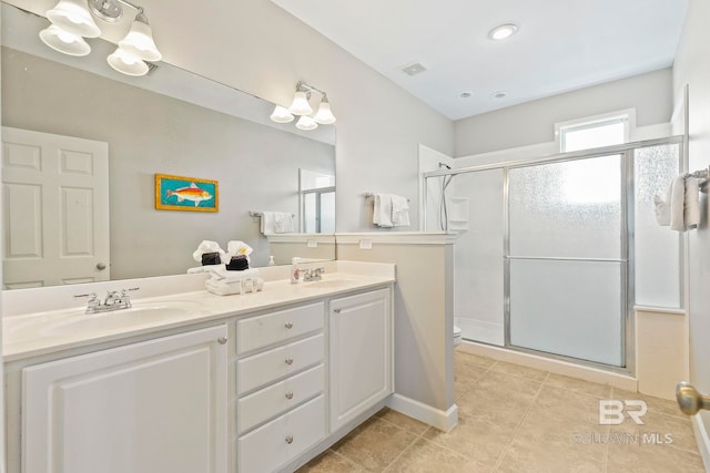 bathroom with tile patterned floors, toilet, walk in shower, and vanity