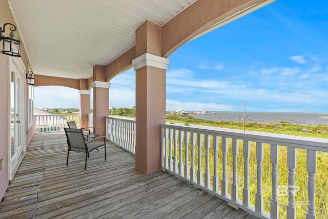 wooden terrace with a water view and a beach view