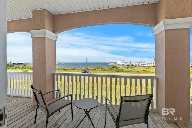 wooden deck featuring a water view